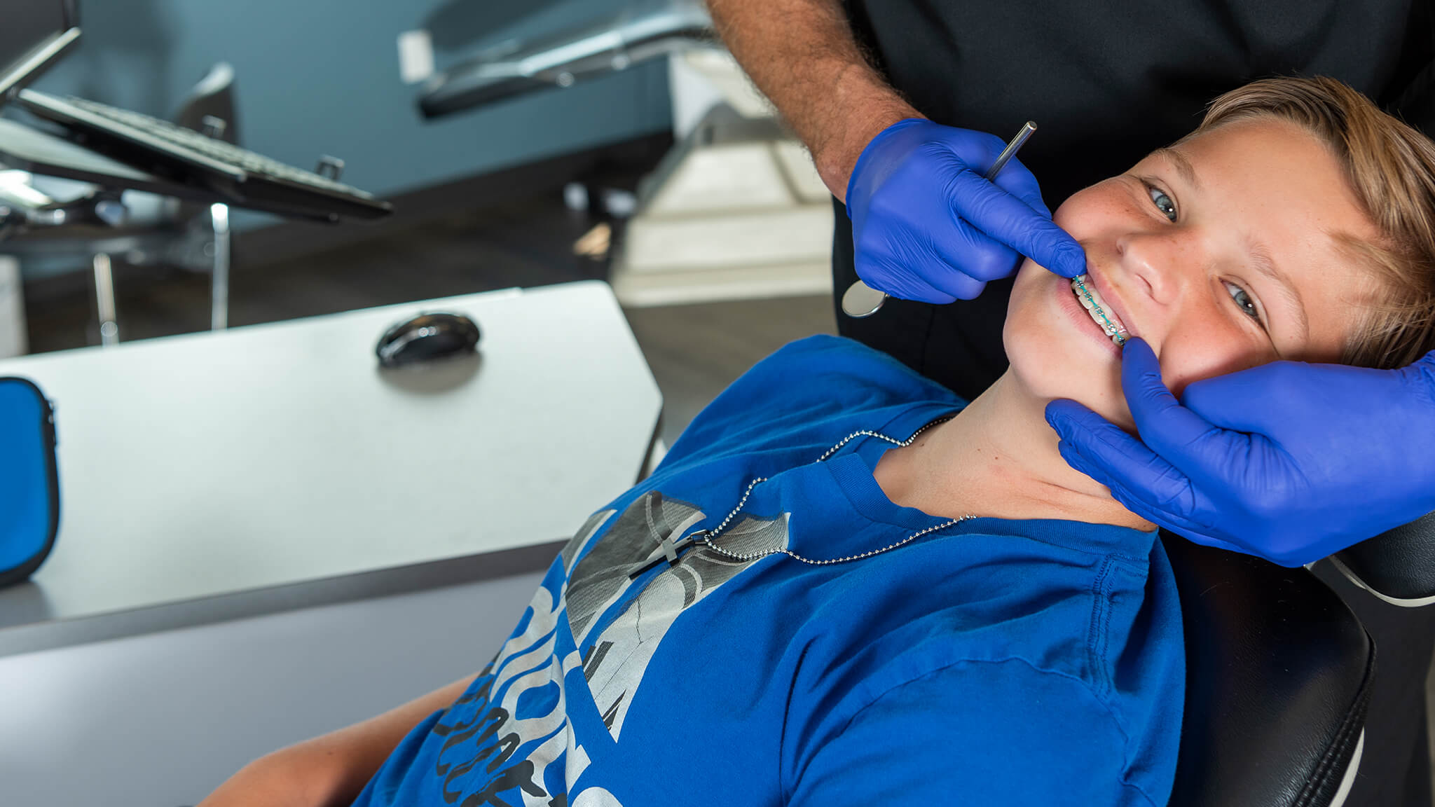 boy with braces being treated on chair