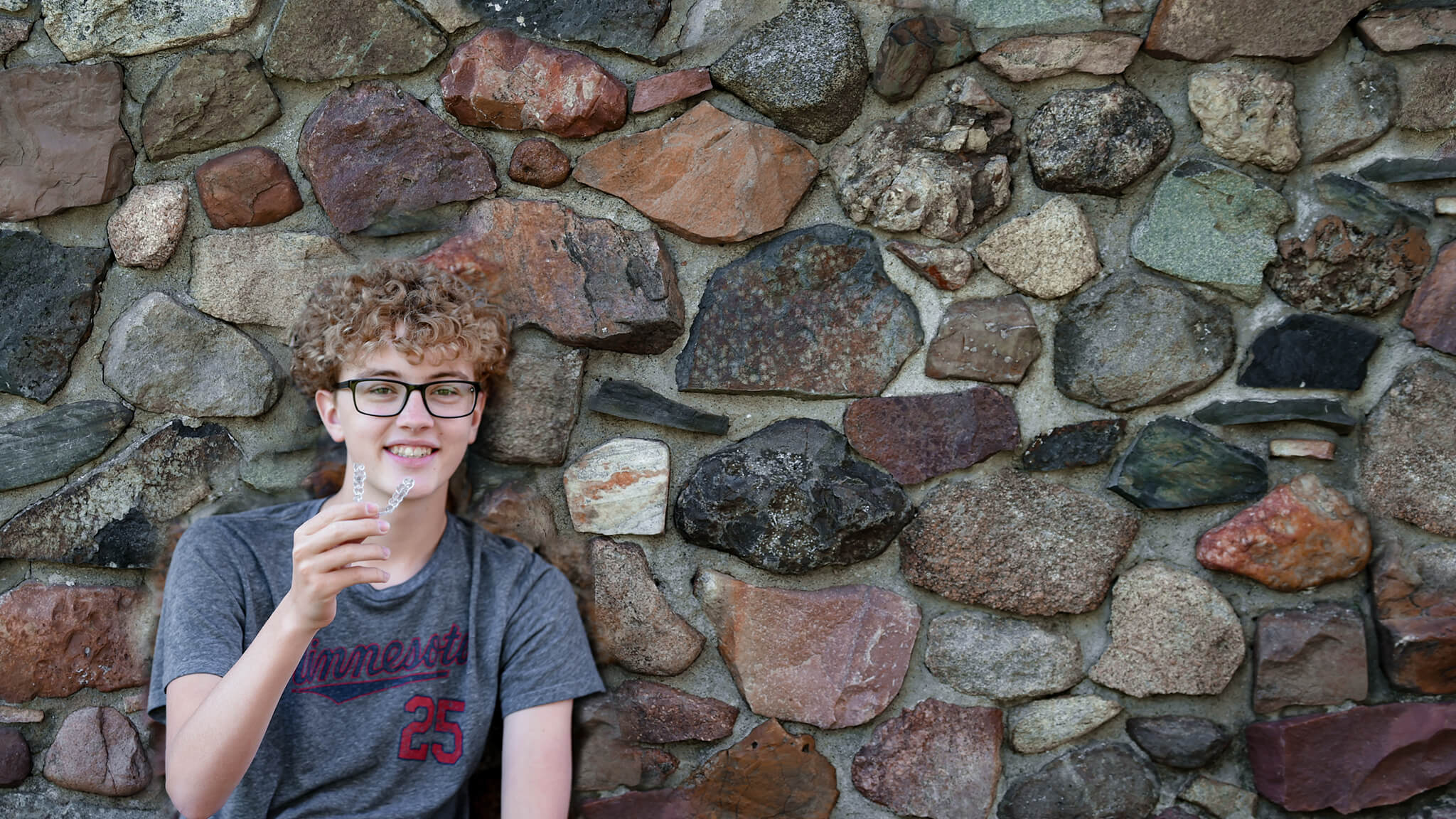 teen boy smiling with invisalign aligner