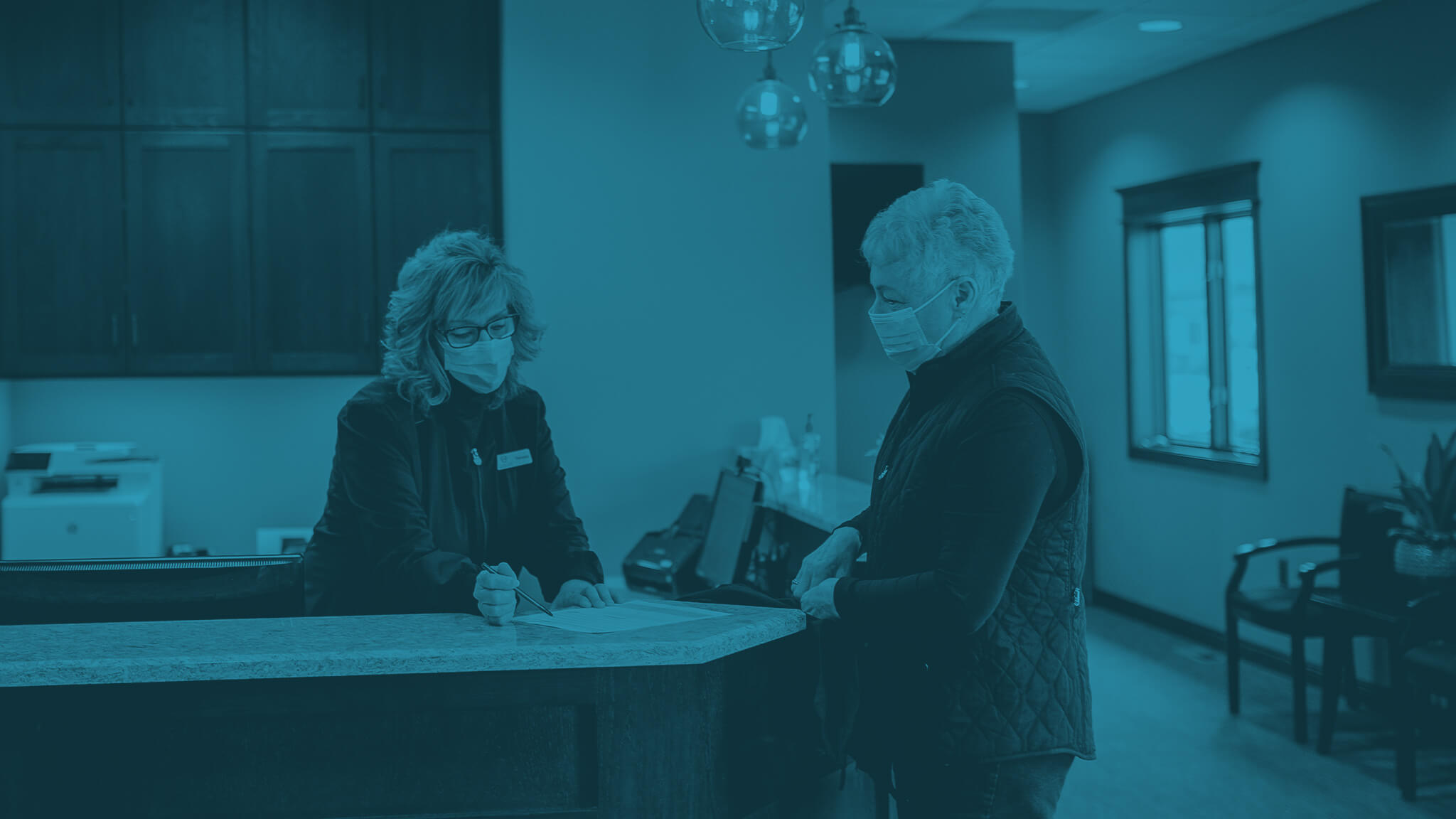 patient speaking with receptionist