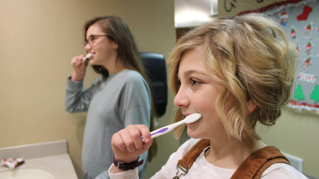 girls brushing teeth