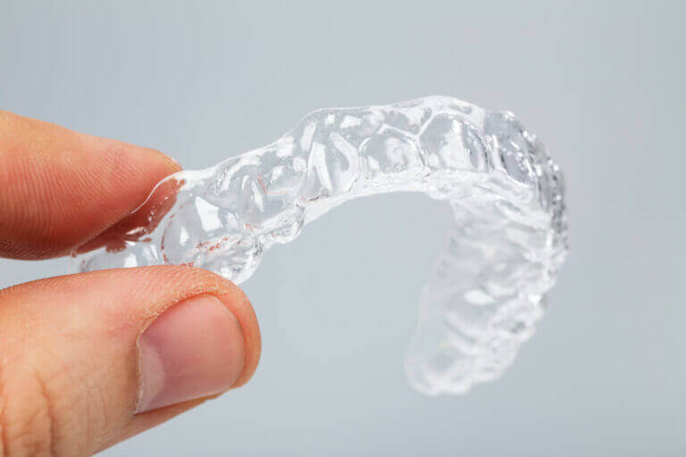 fingers holding retainers