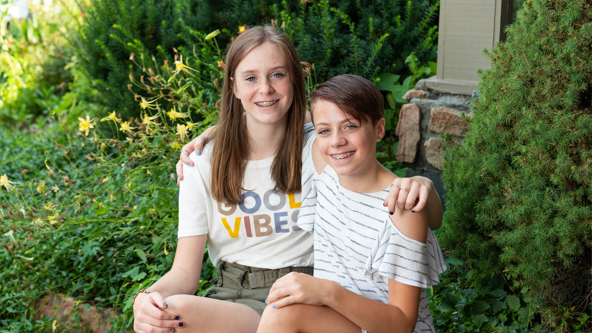 smiling siblings with braces