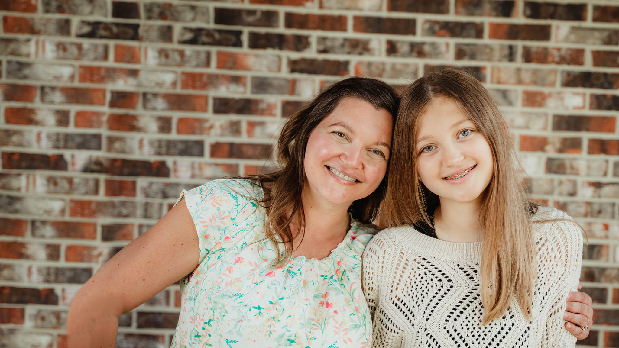 mother and daughter with braces smiling